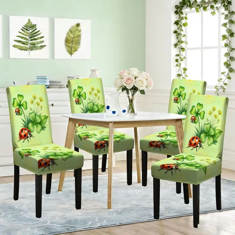 The printed elastic dining chair has a green base color with yellow daisies, two ladybugs and four-leaf clover patterns