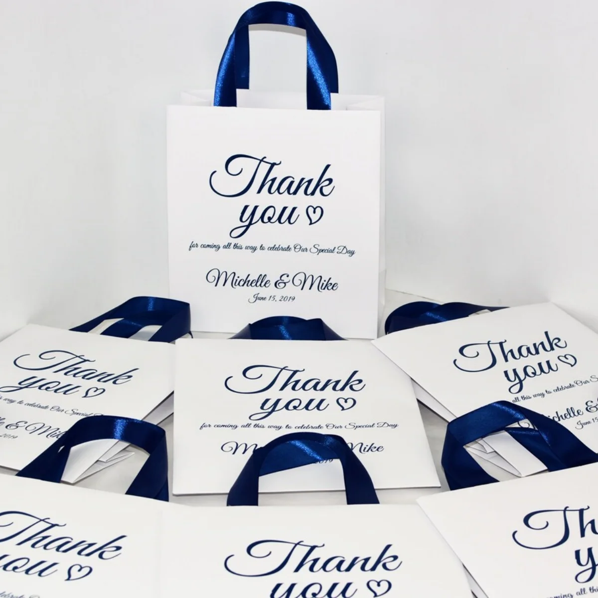 

Navy Blue Personalized Wedding Welcome Bags with satin ribbon handles and names, Elegant Wedding Thank You favors for guests