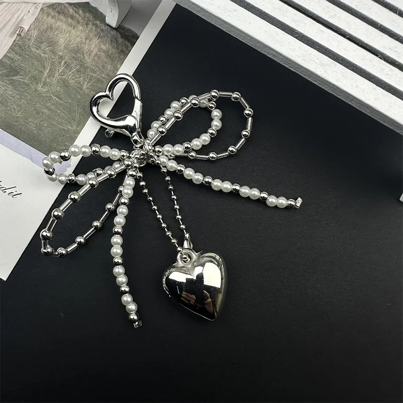 حقيبة جديدة على شكل فيونكة لؤلؤية على شكل قلب مصنوعة يدويًا لحقيبة الهاتف وحقيبة الملابس والأحذية وإكسسوارات الحقائب