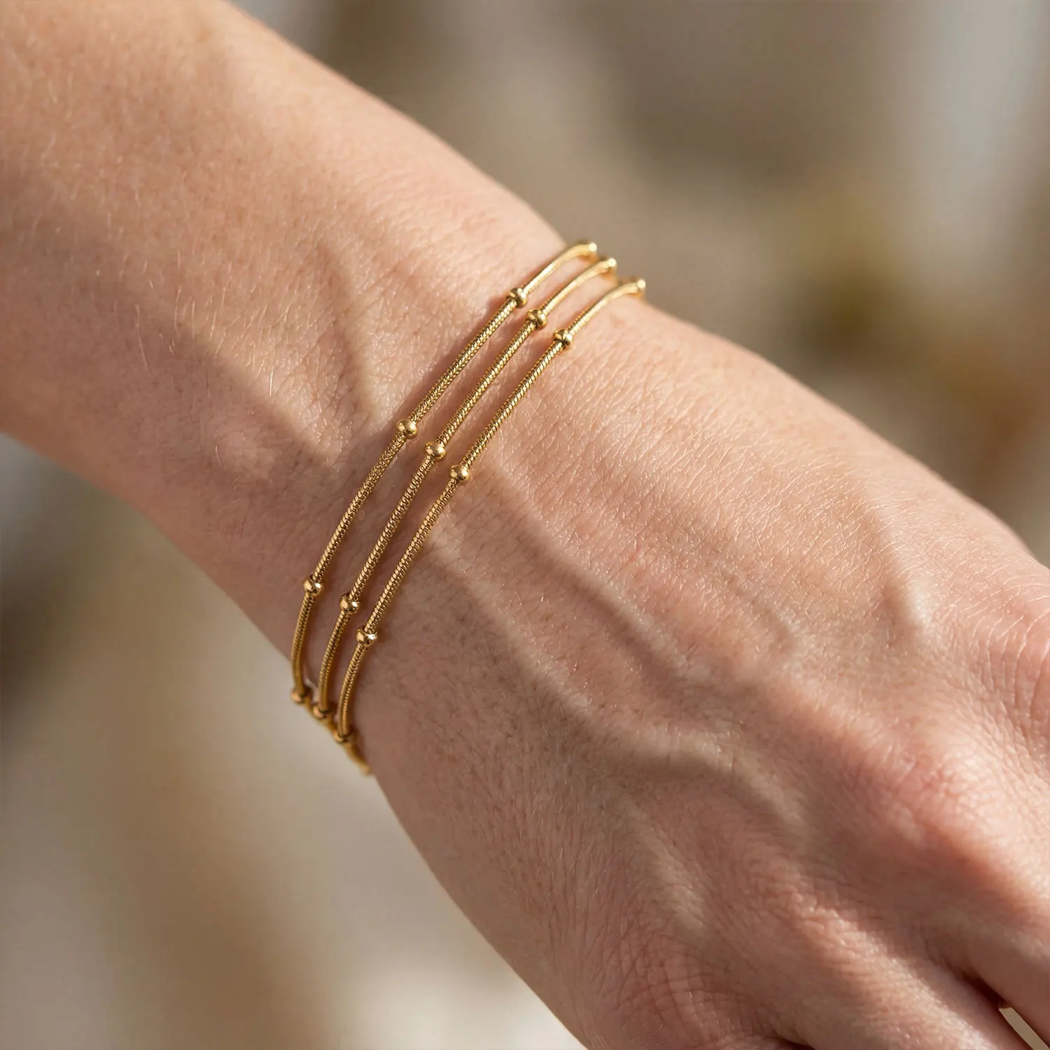 

Stainless steel plated 18K gold bracelet with multiple layers of bead stacking, designed as a jewelry gift for women