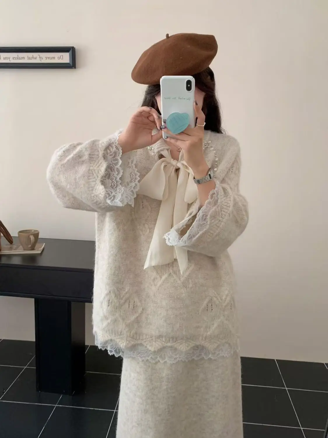 

A stunning young lady is dressed in a complete Korean-style, laid-back, bow sweater and knitted skirt two-piece set