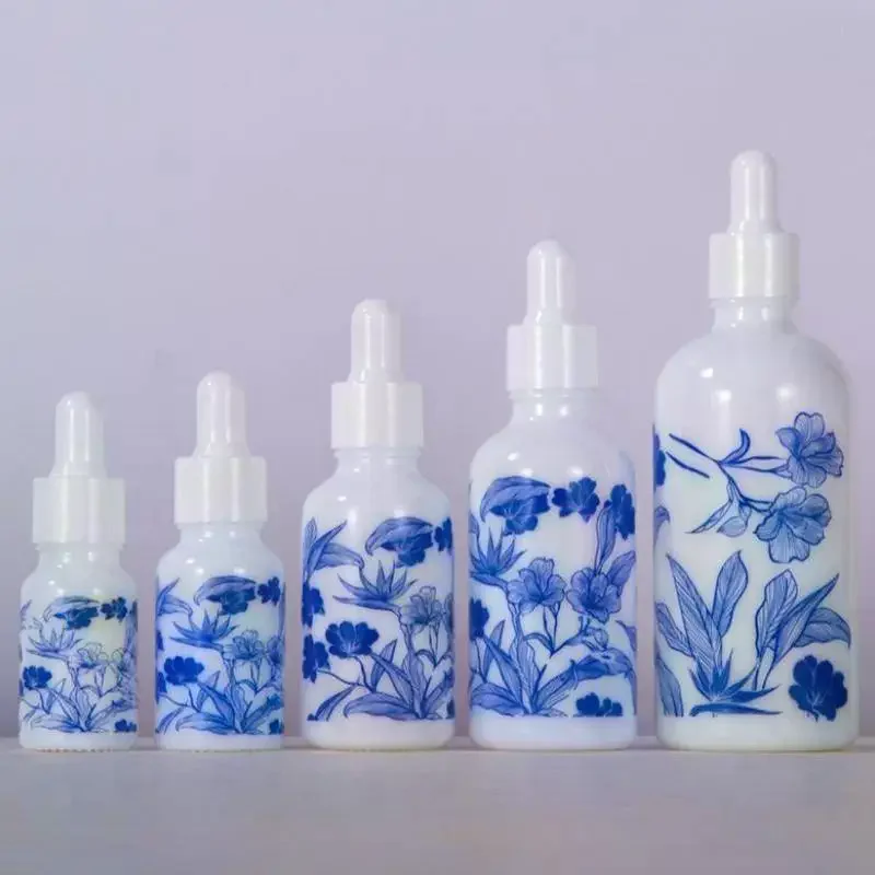 White Floral Print Glass Essential Oil Dropper Bottles With Leak Proof Lids Perfect For Aromatherapy Storing Skincare Blue