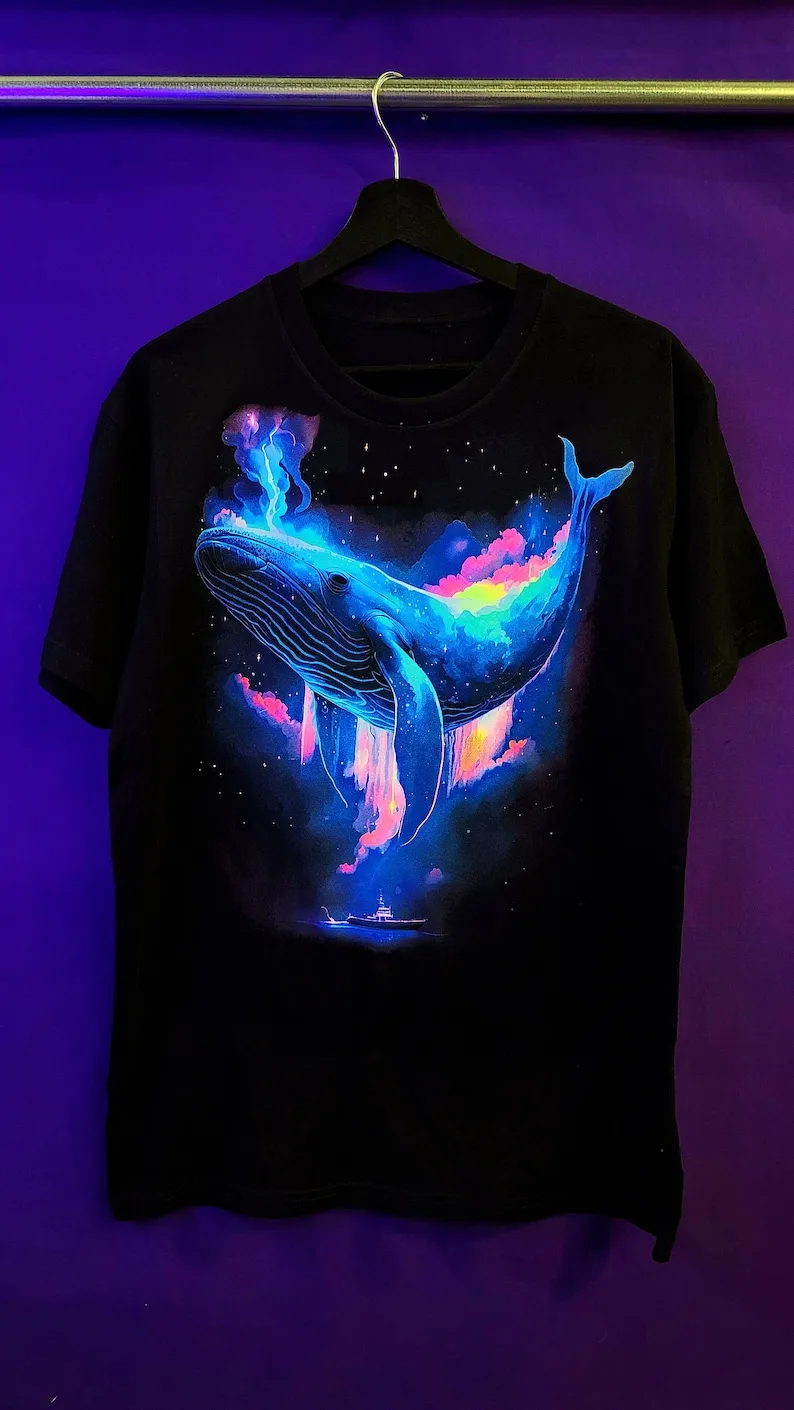 Stand out from the crowd with our T-shirt glowing Space Whale! Order now and elevate your style to the next level