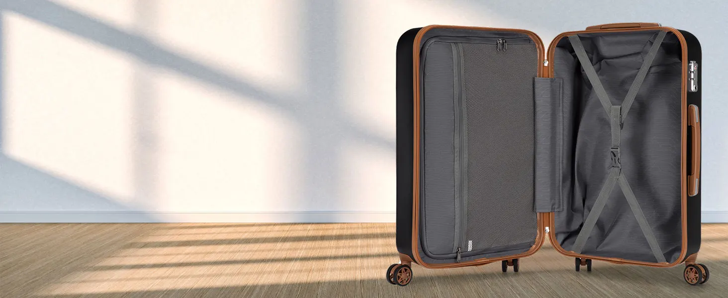 Open hardshell suitcase showing gray interior compartments with cross-straps and mesh divider, highlighted by natural lighting.