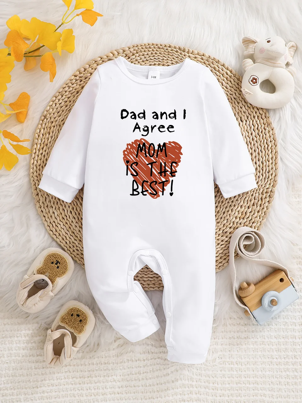 A baby long-sleeved onesie with interesting letter prints. It features a buttoned design for easy putting on and taking off