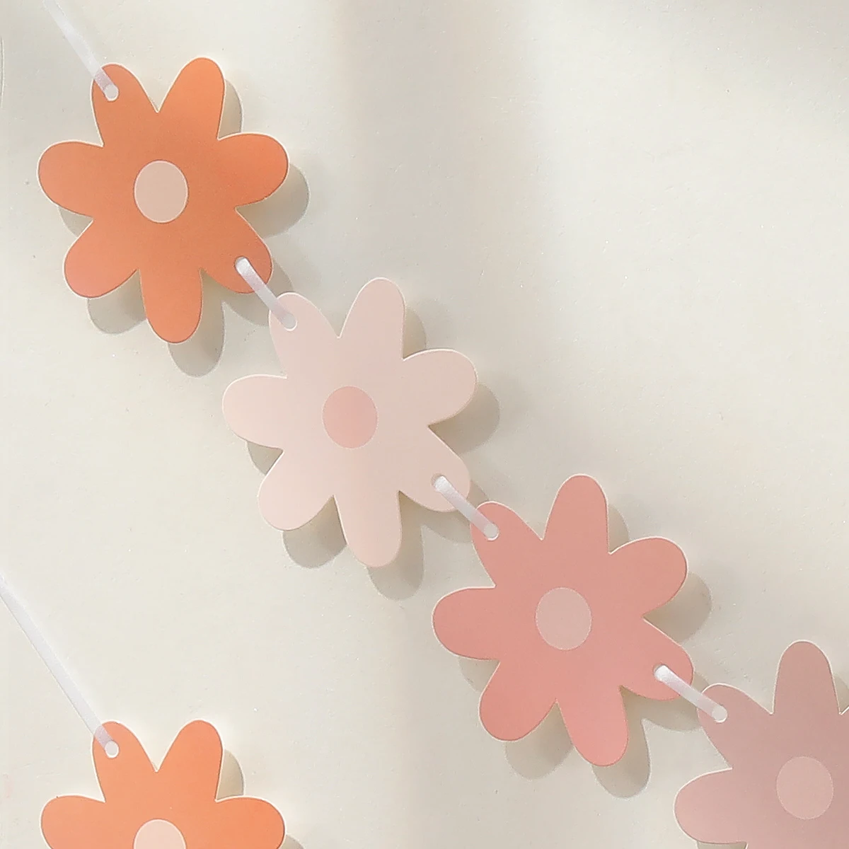 Gradient daisies pull the banner to decorate the holiday party decorations