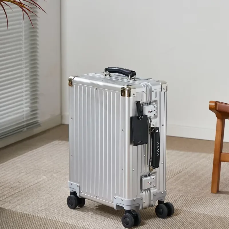 Classic silver aluminum-magnesium suitcase with hard shell and black accents, suitable for business travel