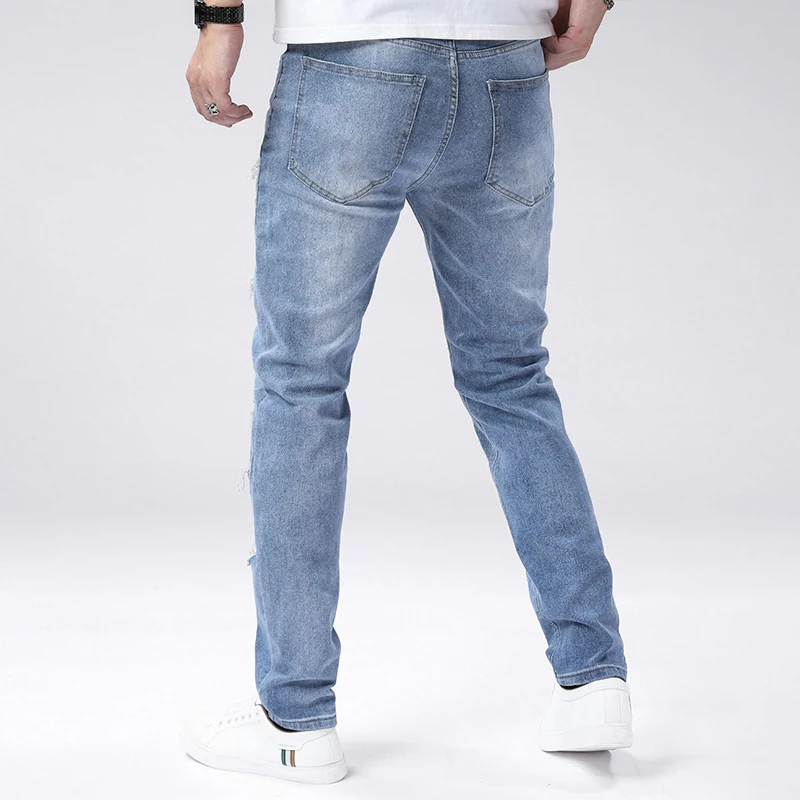 Jeans strappati skinny azzurri autunnali da uomo Pantaloni lavati vintage a media elasticità Pantaloni alla moda casual alla moda quotidiana
