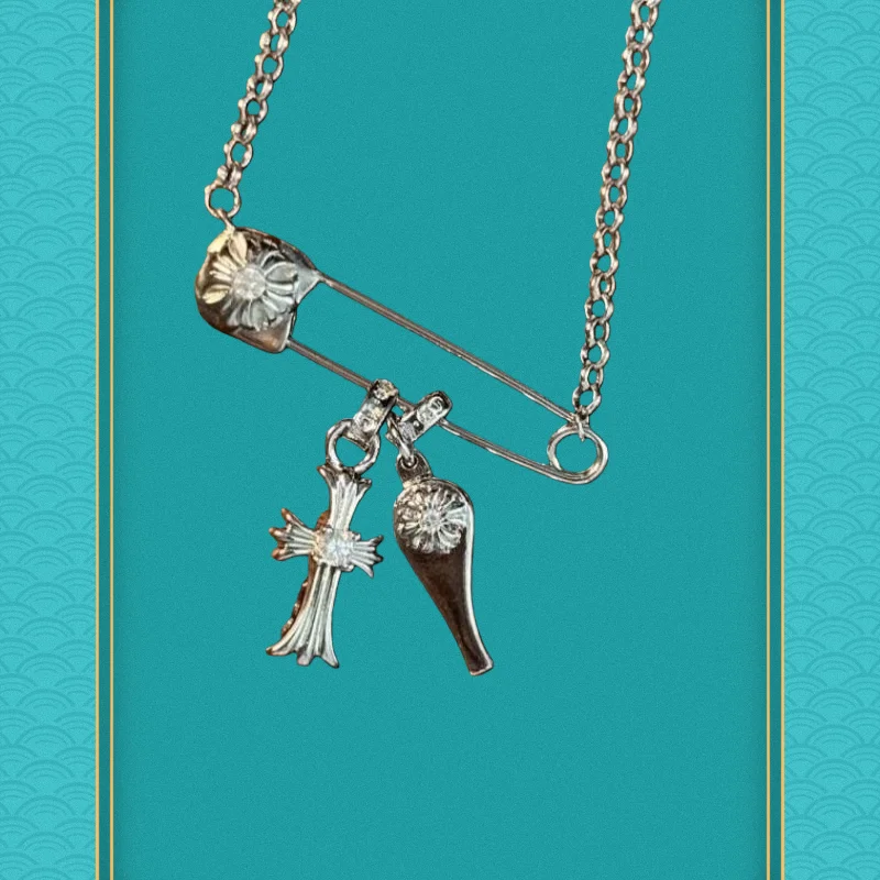 

Gold Safety Pin Necklace: Crystal Cross & Floral Charms