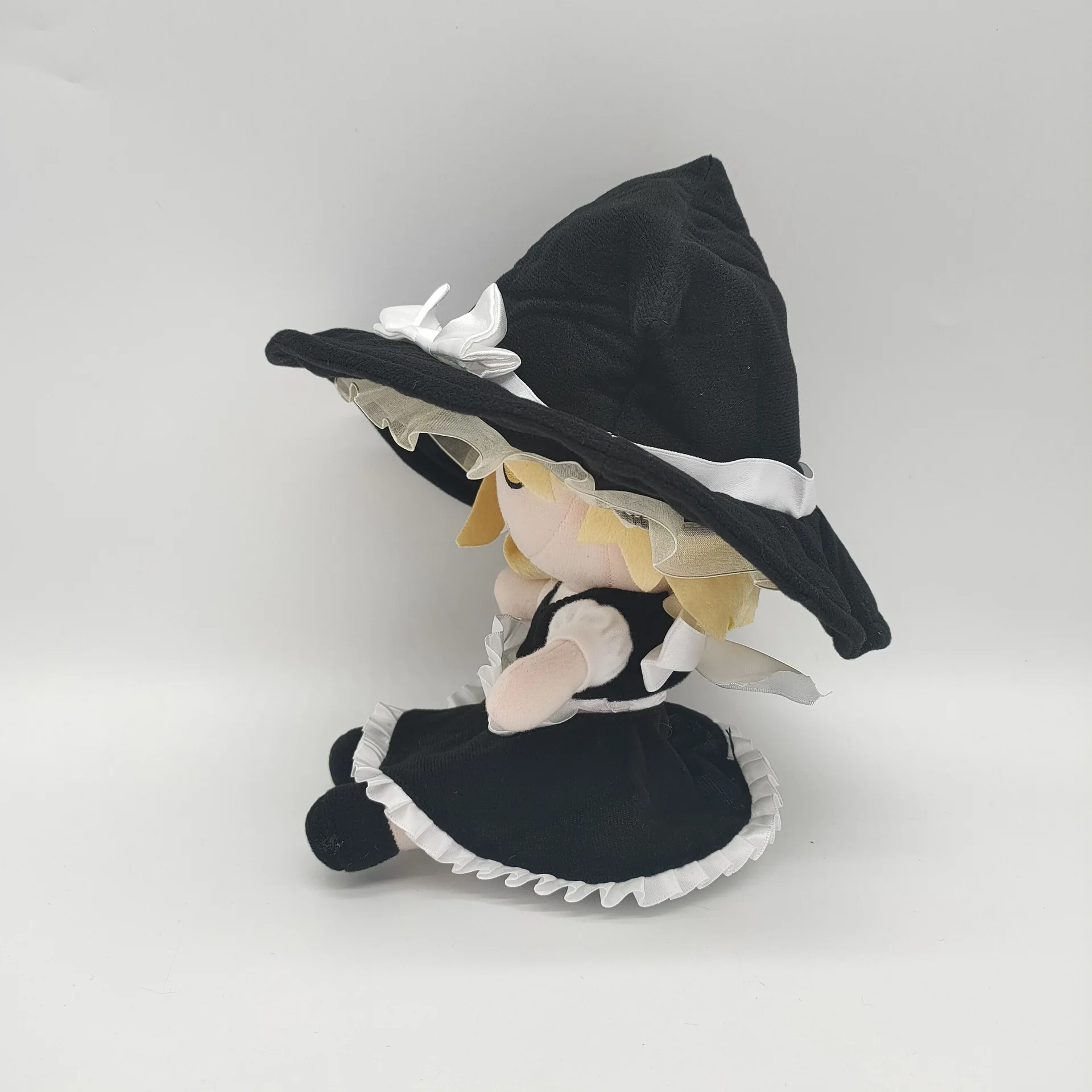 Yellow haired little girl wearing black hat, plush toy, creative design, cute and fun, soothing and accompanying