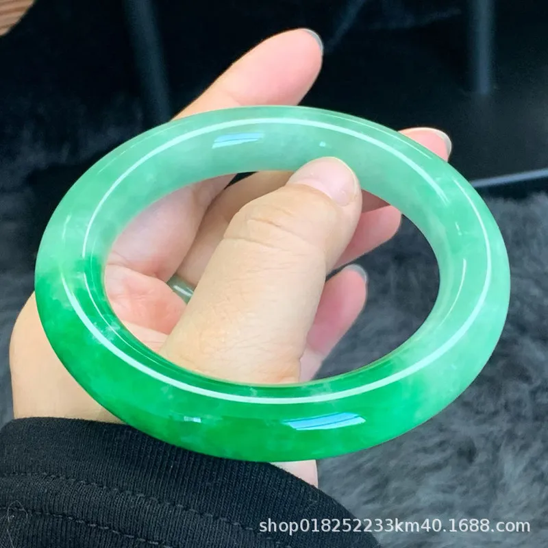 A natural large-sized Burmese bracelet a single piece of jade with an icy smooth texture and a vibrant bright green co