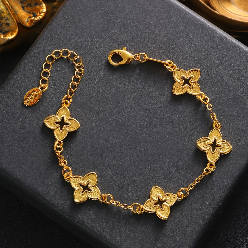 A simple and fashionable hand chain in the shape of a golden four-leaf clover, trending in the European-American style.