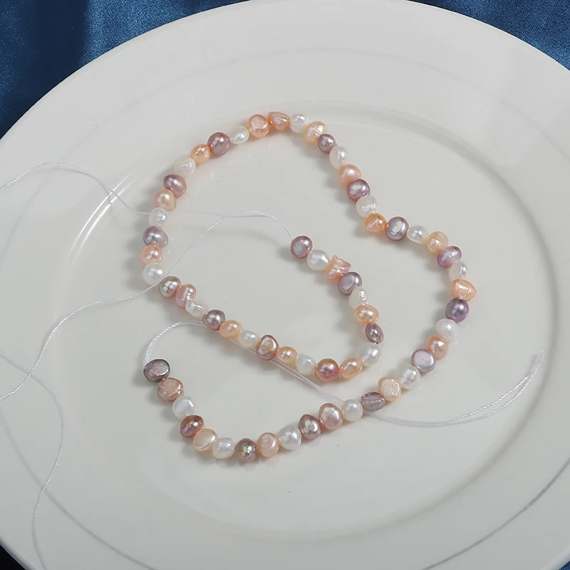 5-6mm candy-colored horizontal-hole Baroque two-sided polished small stones, a strand approximately 35cm in length.