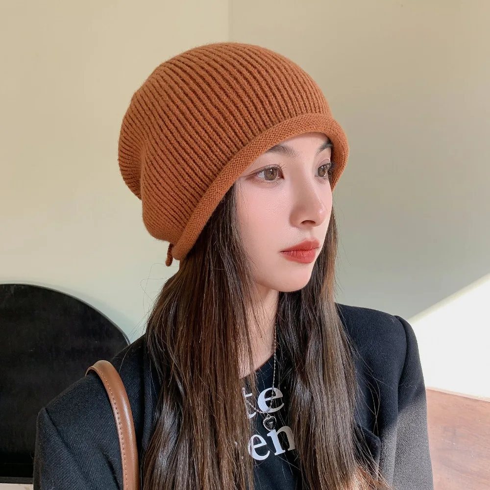 

2024 Knitted Pile Cap Ear Protection Solid Drawstring Stack Hat Windproof Winter Warm Cap Women