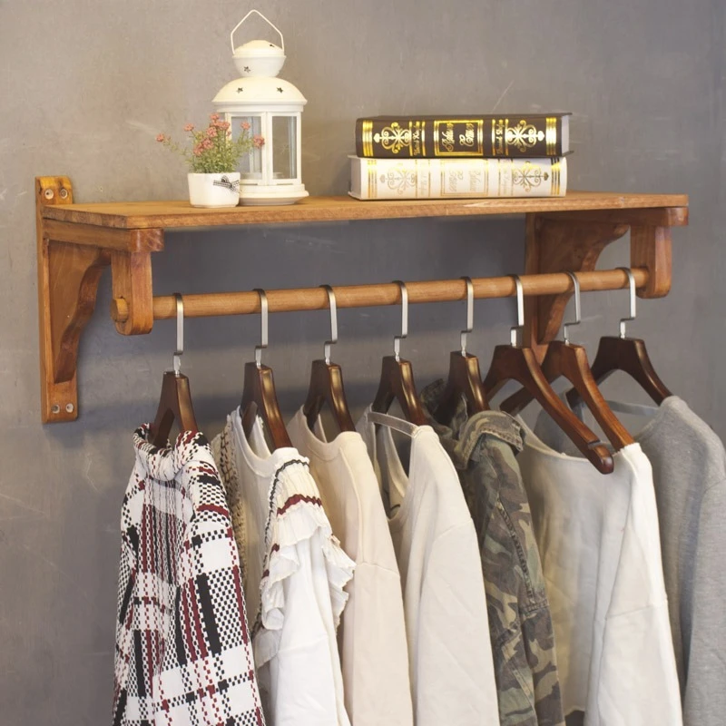 

Clothing store wall display rack, shelf for women's clothing store, retro and old wooden clothes hanger, simple clothes