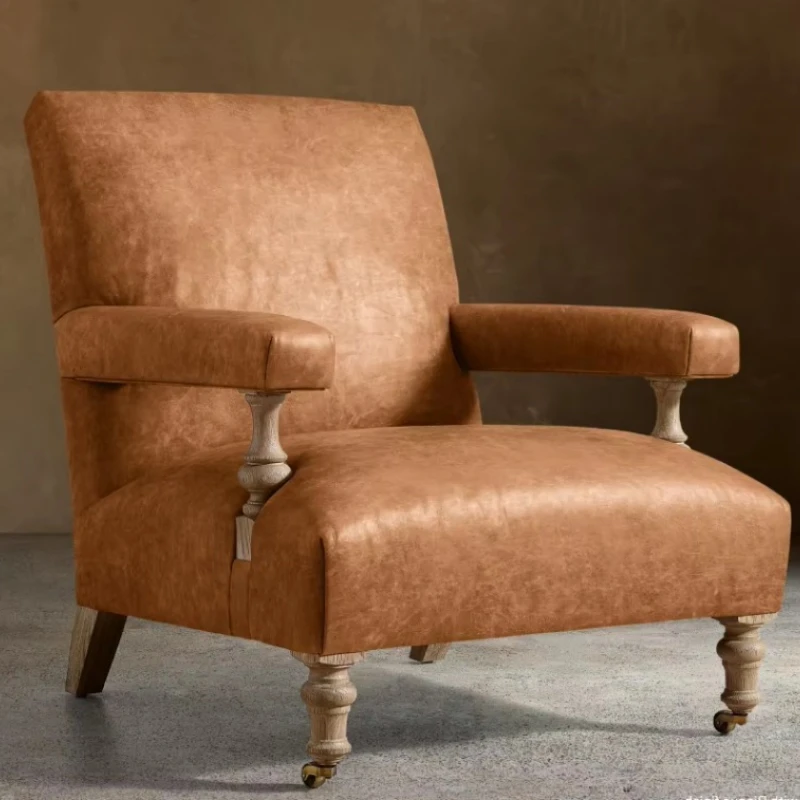 Leather-upholstered armchair with bleached oak legs and brass casters, country-style lounge chair for study villas