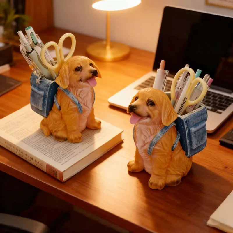 A realistic sitting golden retriever puppy dog figurine wearing a denim blue mini backpack filled with colorful pens and scissors displayed on a wooden office desk next to a laptop