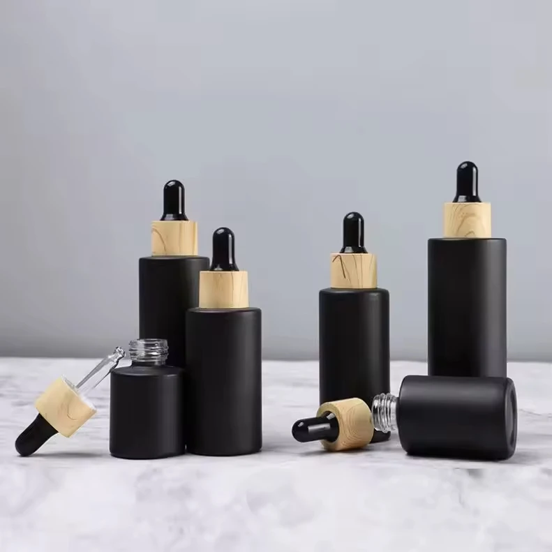 

Bulk Order Empty Matte Black Glass Dropper Bottle amboo Wood Refillable Essential Oils Skin Care Containers With Bamboo Lid