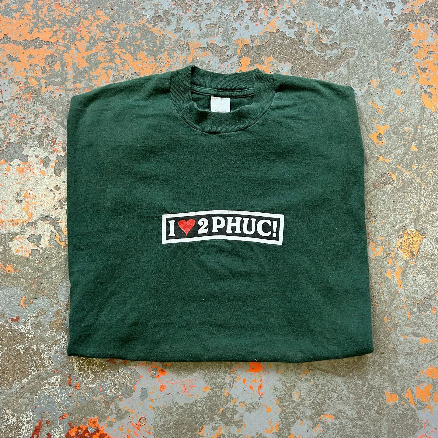 Loose Short Sleeve T-Shirt in Olive Green with White Highlighting American Satire Slogan by Wang Youbing Studio Unisex Cotton...