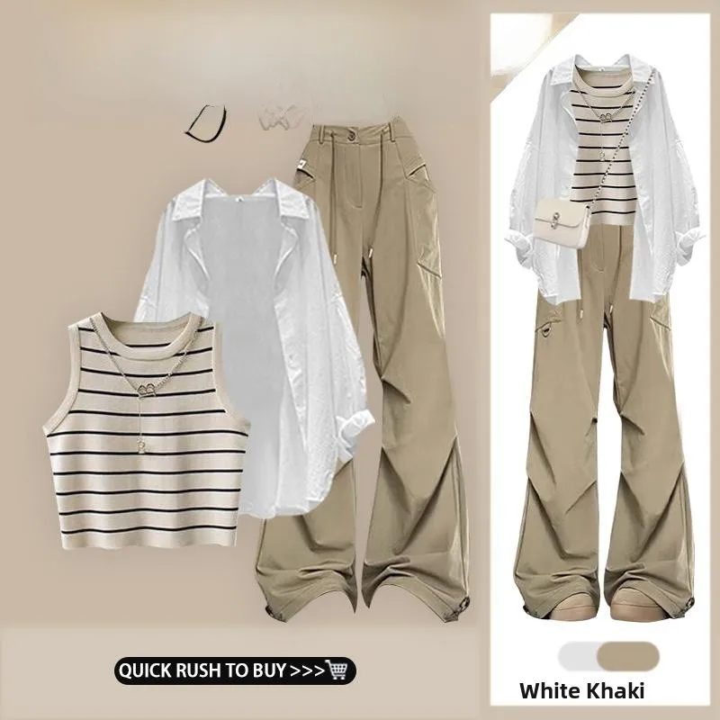 

Комплект из трех предметов: белая рубашка, полосатый жилет и брюки с высокой талией и широкими штанинами. Женская мода Весна 2025