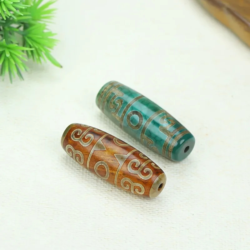 

Новый кулон из зеленого и коричневого старинного агата с бусиной Дзи в три глаза.