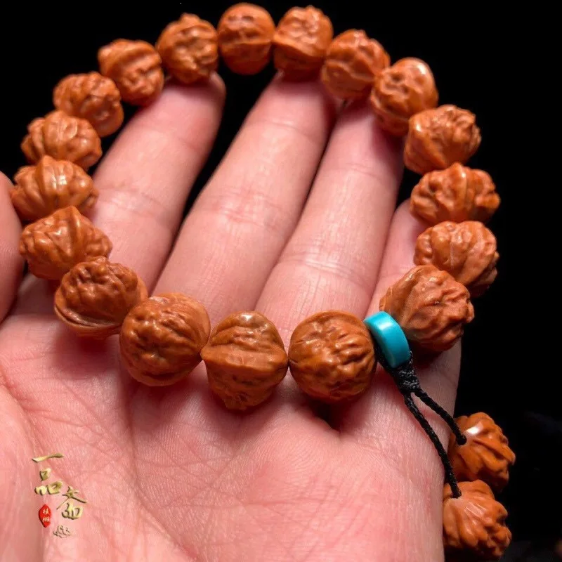 bracelet with a small golden and dragon pattern carved head, toad art craft walnut