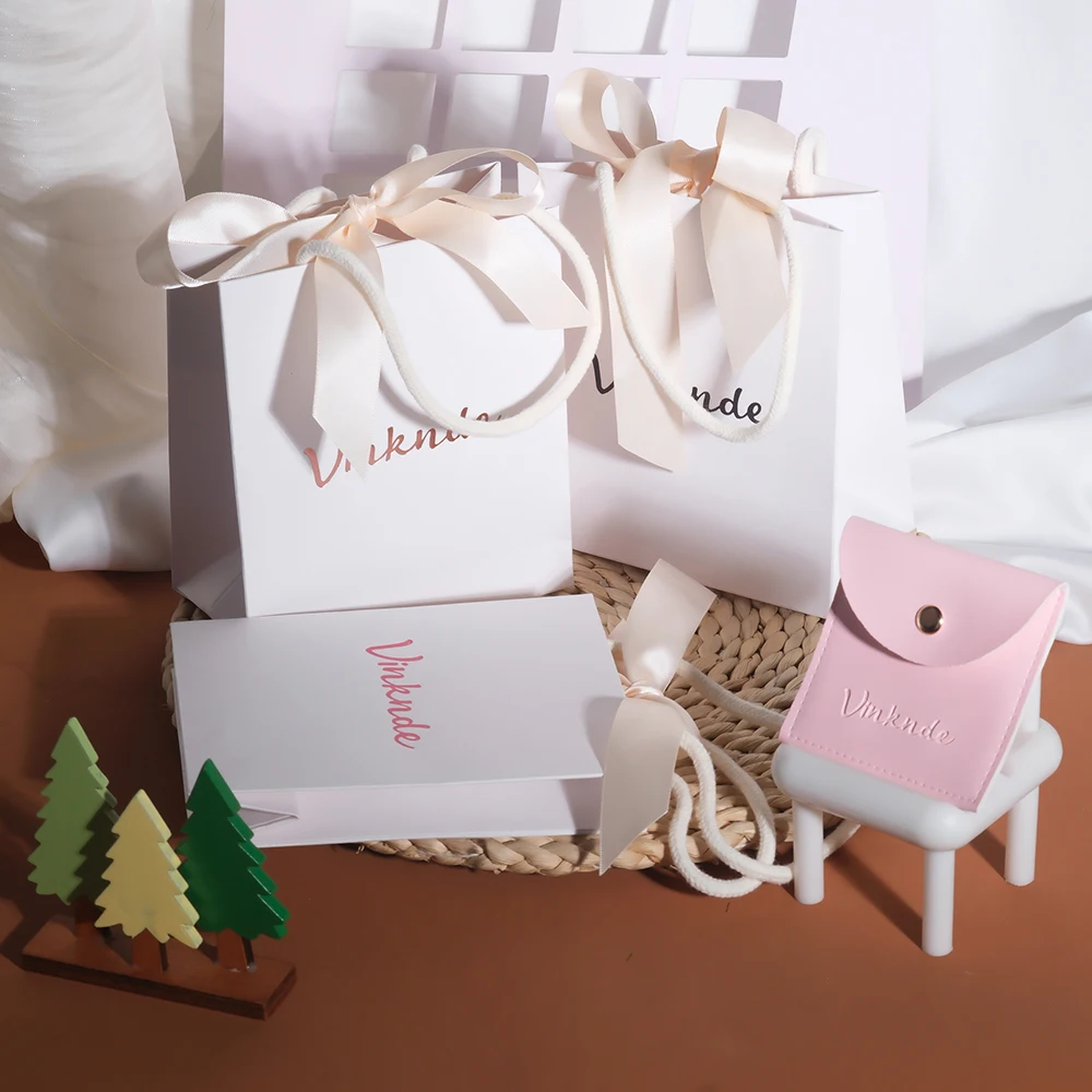 

Custom Logo White Paper Bags with Beige Ribbon Bow Handle Portable Birthday Gift Shopping Birthday Wedding Christmas Sack