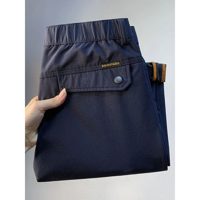 Pantaloni casual da uomo larghi a tubo dritto per la primavera e l'autunno 2025, pantaloni da pendolarismo alla moda da uomo elastici con tasca con cerniera di tendenza