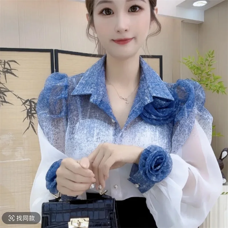 Camicia con protezione solare a fiori tridimensionali con abiti a maniche lunghe dal design Sense e top Joker con temperamento nuovo 2025 da donna