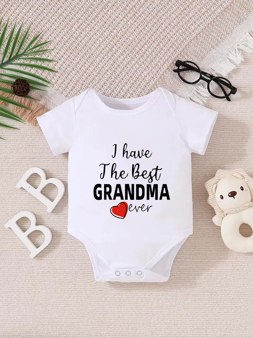 Playful letter-printed baby short-sleeve triangle bodysuit. Button closure for easy dressing, machine washable