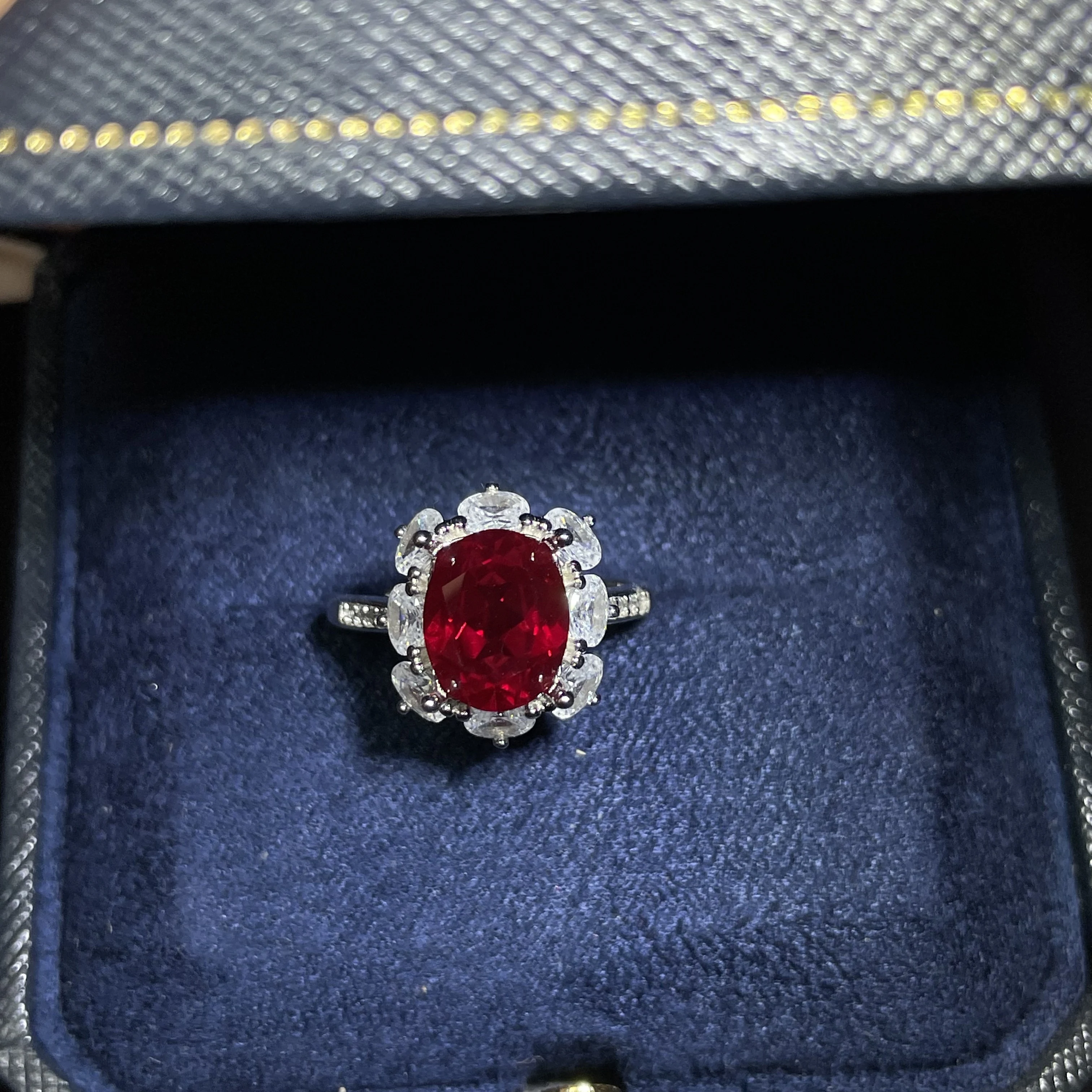 Oval-shaped single 6-carat ruby set in a square-cut diamond ring, shining for a banquet party, wedding or jewelry collection
