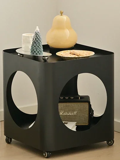 

A few movable mini coffee tables, trolleys, wrought iron side tables in the living room near the cream wind sofa.