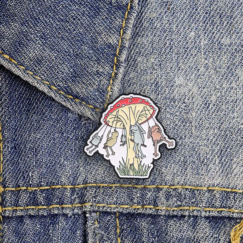 Cute Frogs Swinging On Mushroom Enamel Badge Whimsical Forest Scene Pin Kawaii Nature Metal Brooch Jewelry Gifts