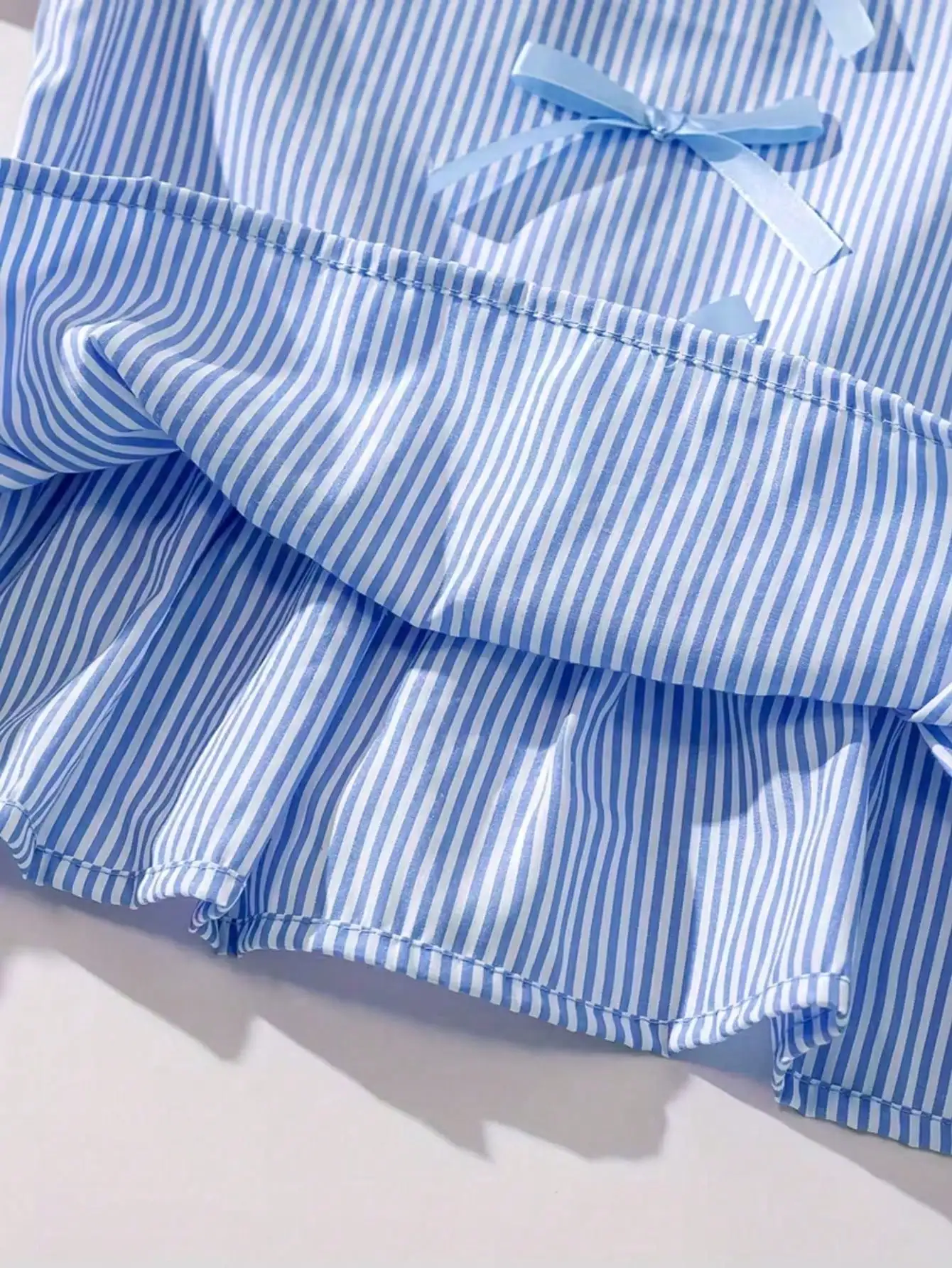 Modisches zweiteiliges Set für Mädchen: rosa-weiß gestreifter Rundhalspullover mit Schnürung, Schleife und Rüschenrand + rosa gestreifte Schmetterlings-Shorts. – Detail 20