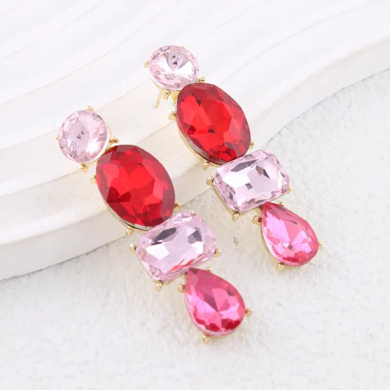 Luxurious and elegant long earrings with striking colored gemstones, perfect for travel, public relations, and social occasions
