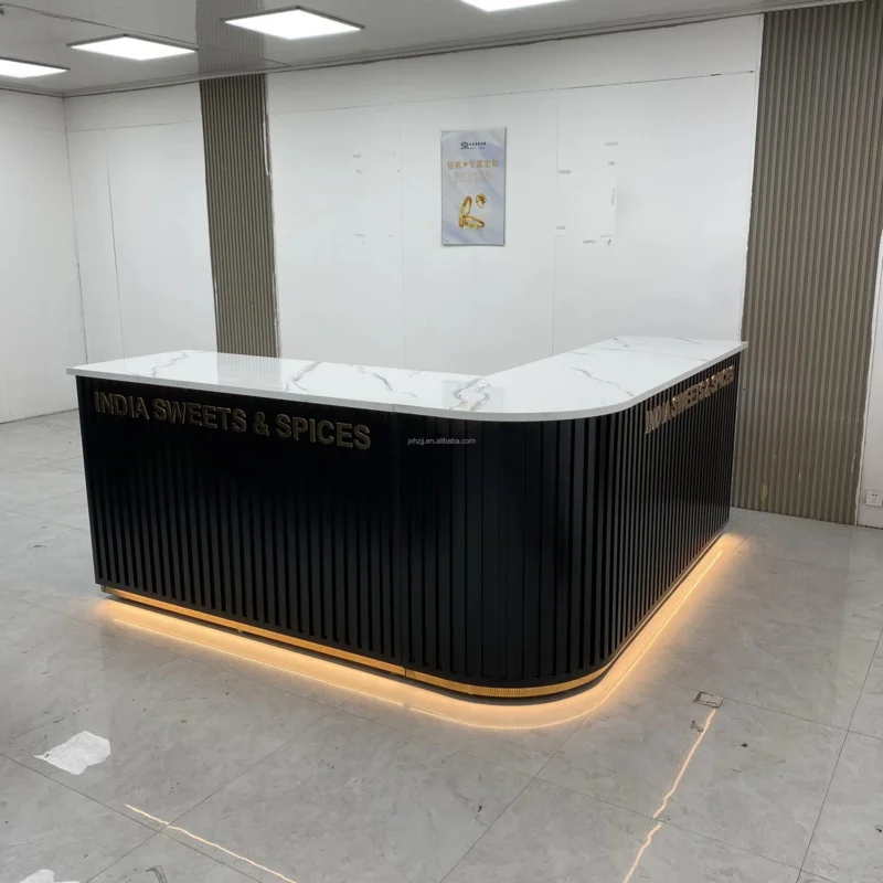 

Customize.Sleek Curved Reception Counter - Black Ribbed Panel with Gold Trim & Marble Top Modern Retail Spaces