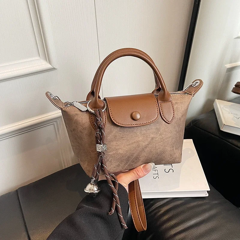 Elegancka torebka damska w stylu vintage, skórzana torba typu tote, klasyczna damska torba na ramię z mosiężnymi nóżkami i górnym uchwytem.