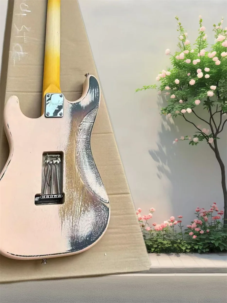 Heavy relic light pink electric guitar inlaid with vibrato bridge striking bar retro tuner chrome hardware