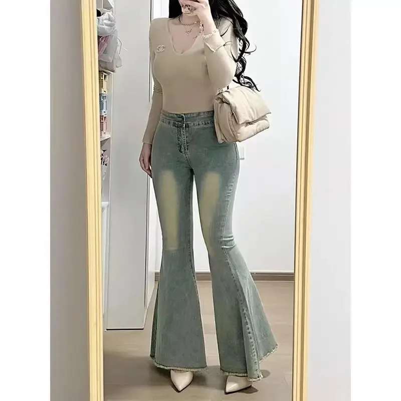 Retro fishtail flared jeans female autumn and winter new slim elastic fashion temperament wide-leg pants with raw edges.