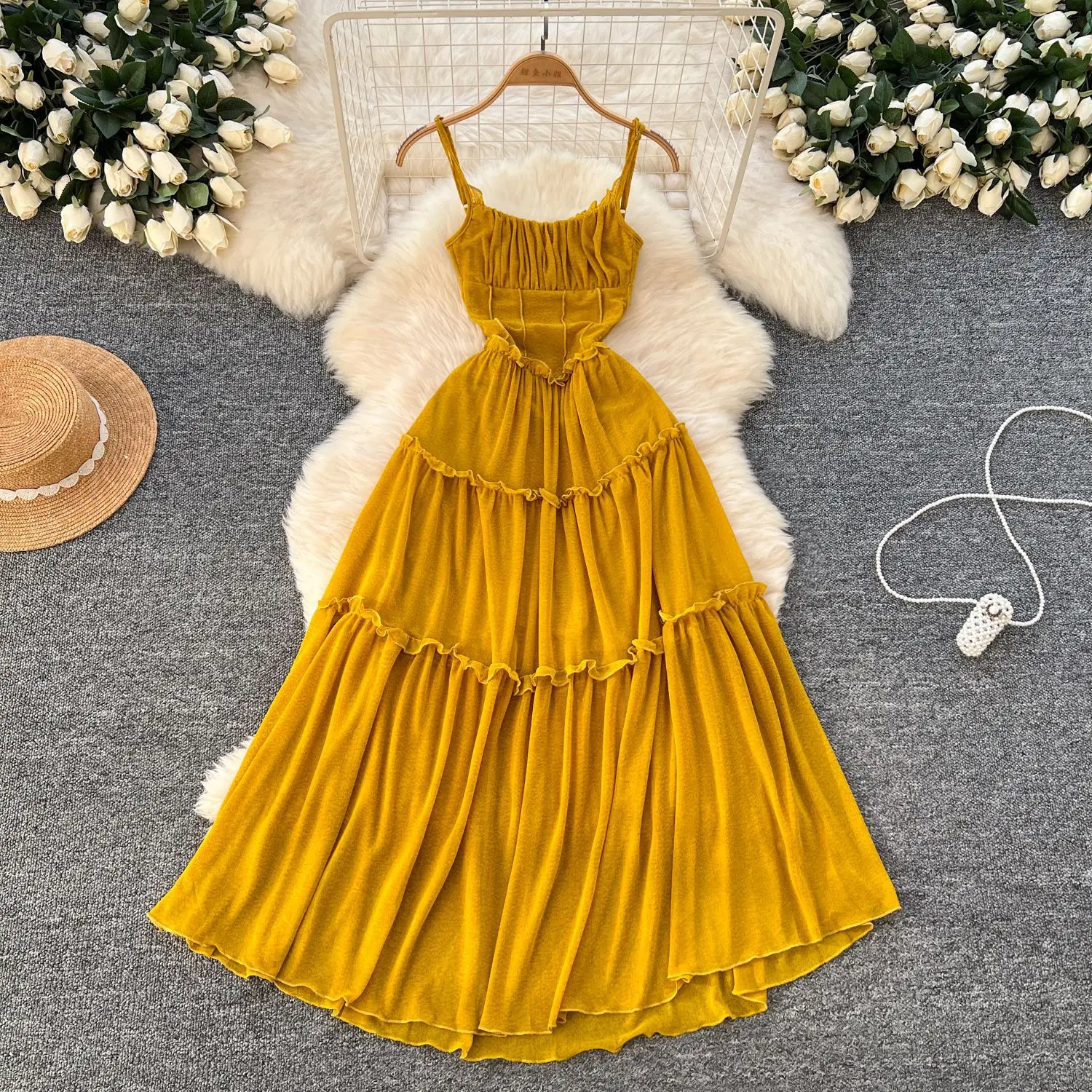 Retro halter dress for women with beachy style, featuring pleated and wide hemmed long skirt.