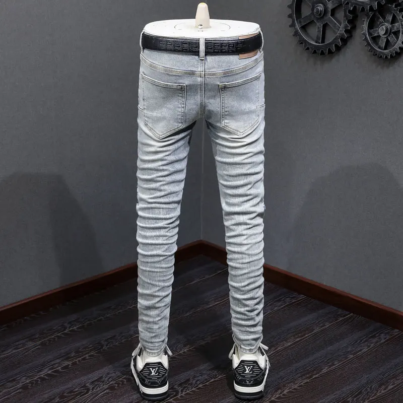 Fashionable new men's light blue jeans, washed, nostalgic, perforated, white patch, elastic, slim fit, painted jeans, hip-hop br