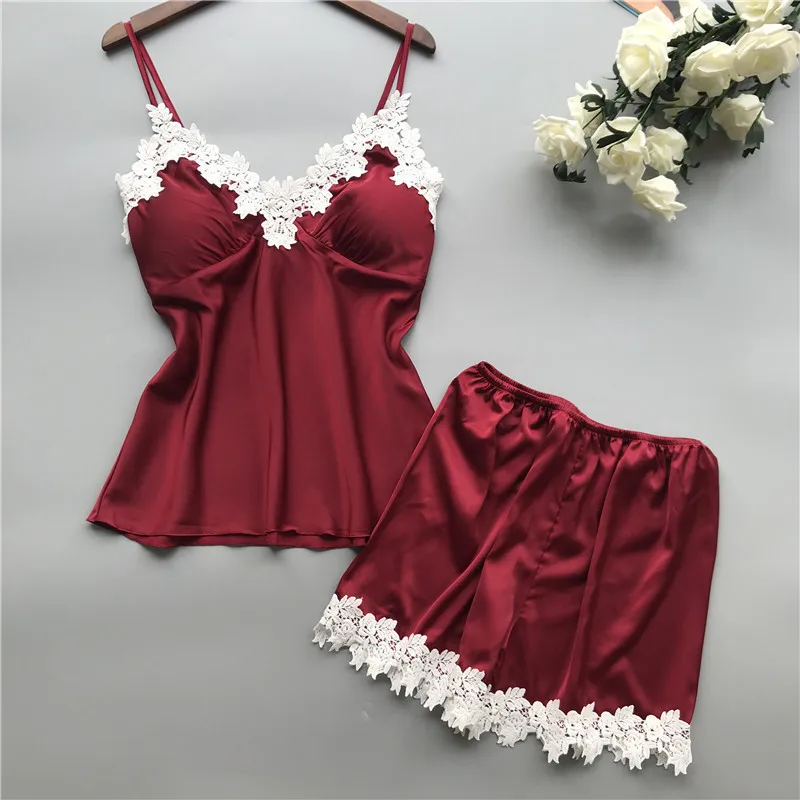 

Women's pajama set of two pieces. Fashionable V-neck stretch satin dress with lace straps and sexy camisole paired with shorts.