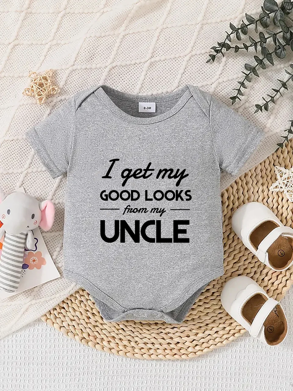 Playful letter-printed baby short-sleeve triangle bodysuit. Button closure for easy dressing, machine washable