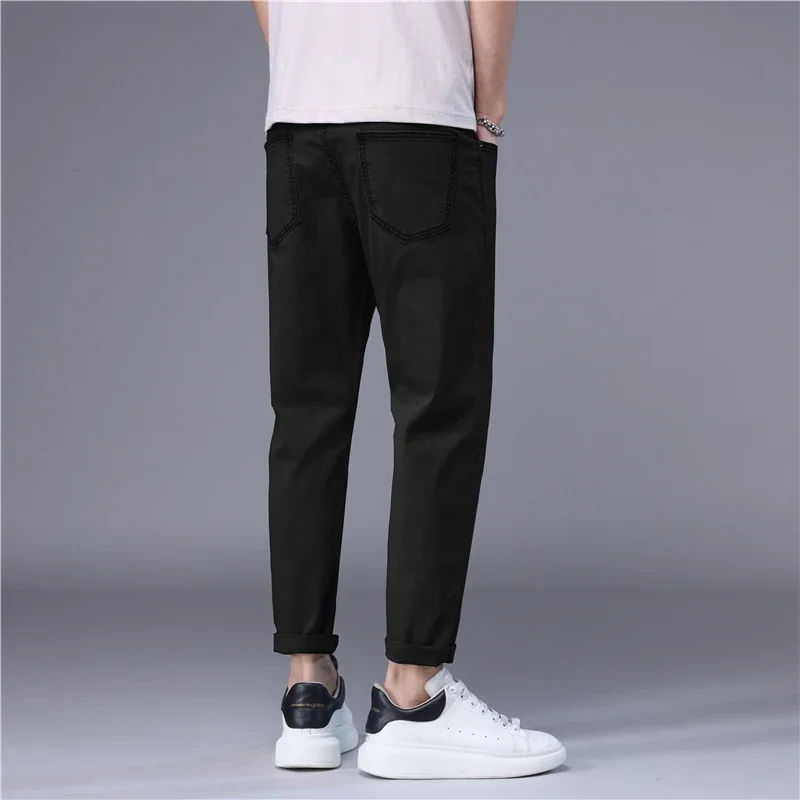 ฤดูร้อนกางเกงยีนส์ผู้ชายบางสไตล์เกาหลีสีฟ้าสีดําสีทึบยืดตรงสไตล์ SLIM FIT เท้า DENIM Cropped กางเกงชาย