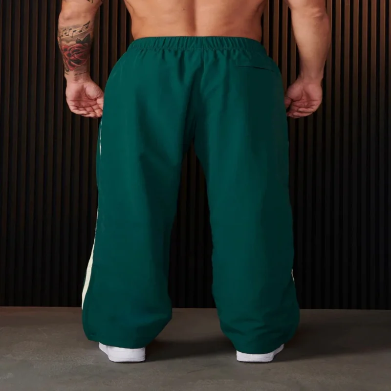 Pantaloni sportivi da giovane uomo pantaloni Casual stampati con giunture a doppia striscia palestra Fitness pantaloni a gamba dritta a vita media