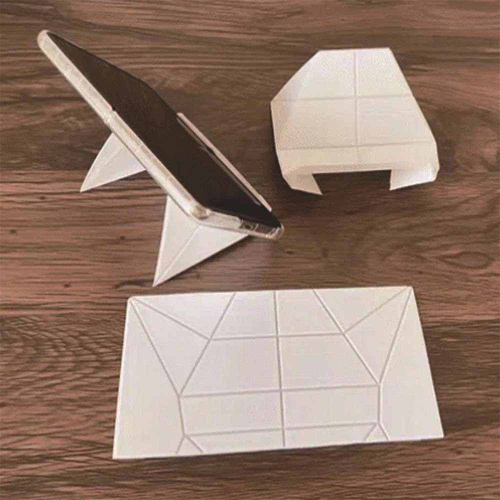 

Phone Stands An Easy-to-carry Origami Phone Stand for Travel and Business Trips, A Desktop Foldable Portable Phone Stand