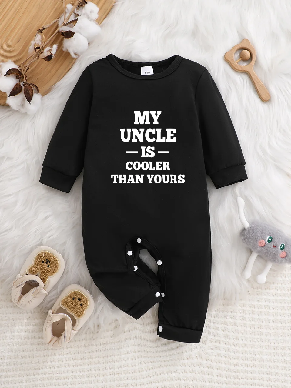 A baby long-sleeved onesie with interesting letter prints. It features a buttoned design for easy putting on and taking off, and