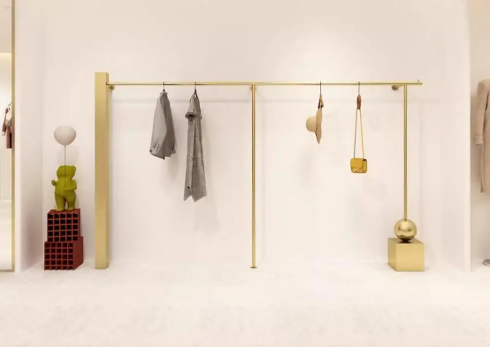 

Wall mounted hangers on clothing store display shelves, gold women's clothing store dedicated display shelves