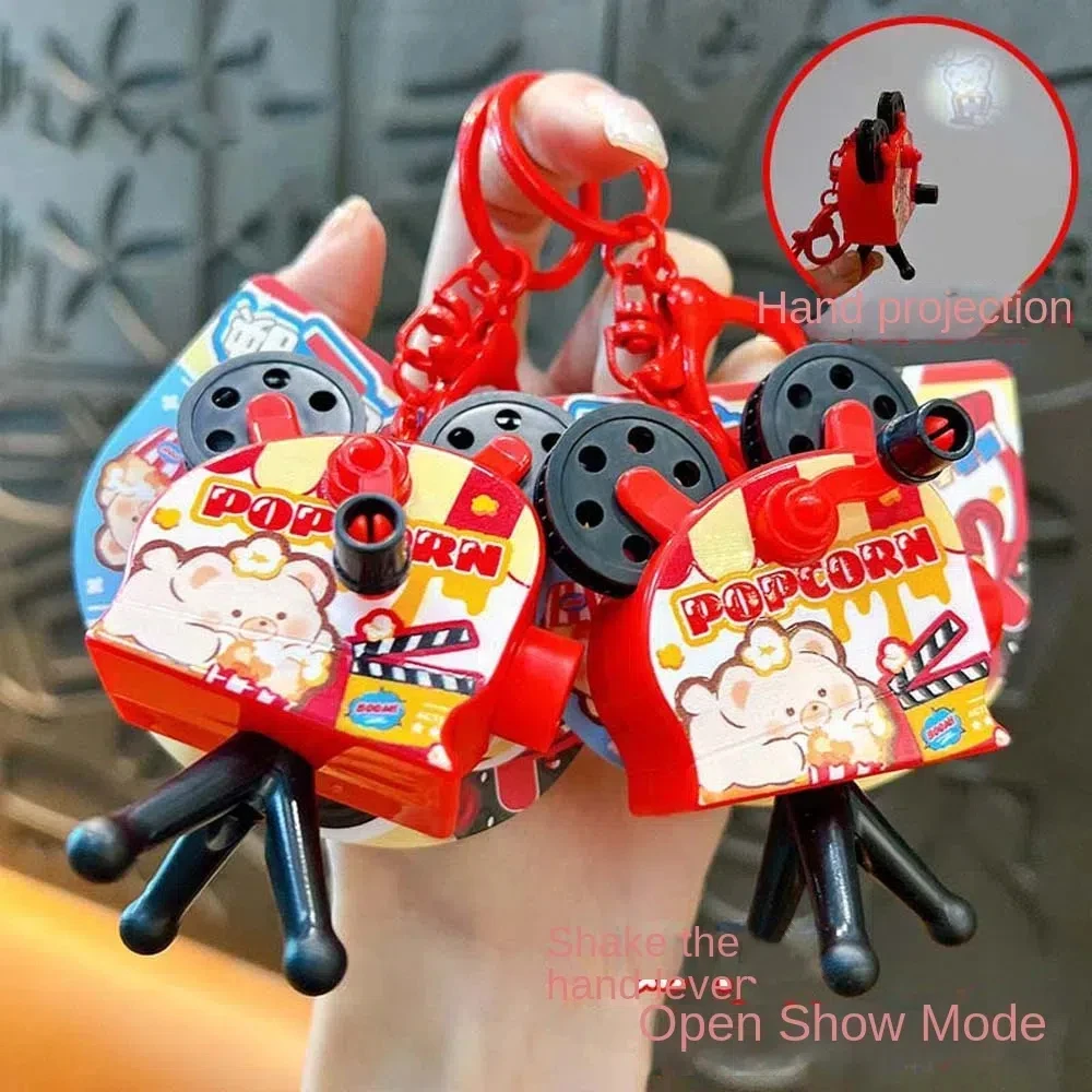 

Projection Camera Camera Keychain Popcorn Hand Cranked With Flashlight Projection Toy Keyring Pendant Kawaii Keyring Ornament