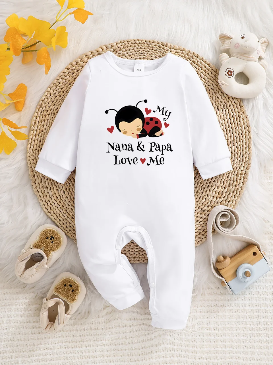 A baby long-sleeved onesie with interesting letter prints. It features a buttoned design for easy putting on and taking off